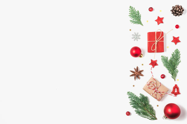 istock Christmas background. Fir tree branches, gift boxes, red decorations, pine cones on white background. flat lay 1189699311