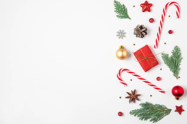 istock Christmas composition. Fir tree branches, gift boxes, decorations, candy, pine cones on white background. top view 1189699354