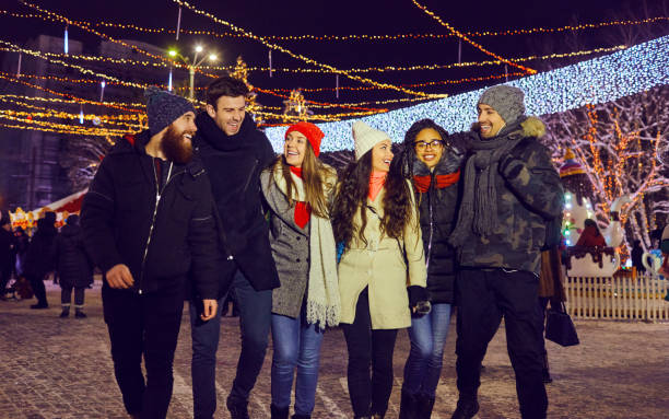 istock Friends have fun walking on Christmas streets at night. 1189702562