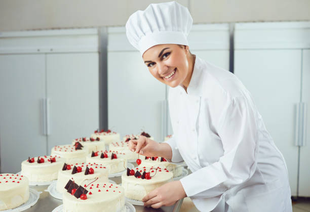 istock Confectioner is holding a cake in her hand in the bakery. 1189703833