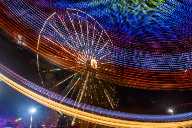 istock Two rides in motion in amusement park, night illumination. Long exposure. 1189705396