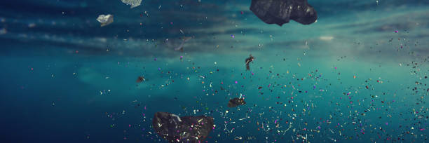 plastic pollution in ocean water, microplastics in the current garbage swimming in sea water, contamination problem, banner format microplastic stock pictures, royalty-free photos & images