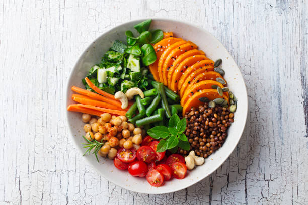 healthy vegetarian salad. lentil, chickpea, carrot, pumpkin, tomatoes, cucumber. wooden background. top view. - butternut squash roasted squash cooked imagens e fotografias de stock