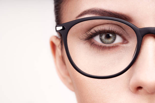 Female eye with long eyelashes in eyeglasses Female eye with long eyelashes in eyeglasses. Model in glasses. Vision correction. Poor eyesight. Spectacle frame. Makeup, cosmetics, beauty. Close up, macro dyed red hair photos stock pictures, royalty-free photos & images