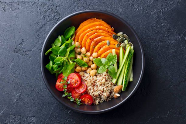 healthy vegetarian salad. roasted pumpkin, quinoa, tomatoes, green salad. buddha bowl. slate background. top view. - butternut squash roasted squash cooked imagens e fotografias de stock