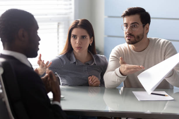 istock Angry clients couple argue with agent for paperwork contract mistake 1189709632