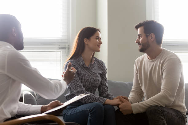 istock Happy couple reconciled after successful therapy session with psychologist 1189709643