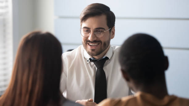 istock Smiling male agent talk consulting multiethnic clients couple 1189709673