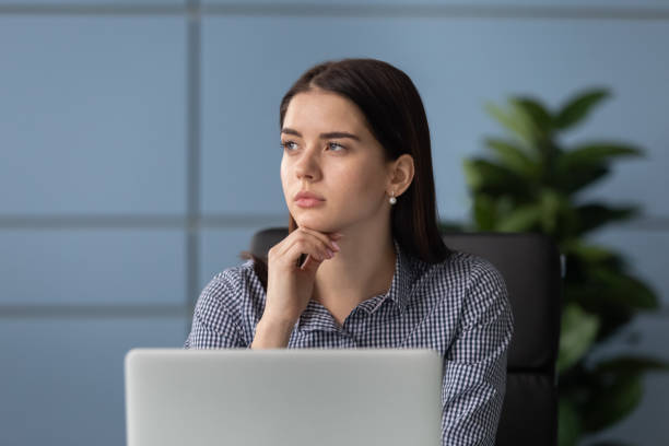istock Pensive female employee look in distance thinking 1189709725
