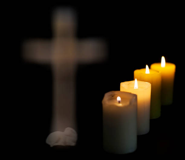 istock Four candles and a cross in the background. 1189710650