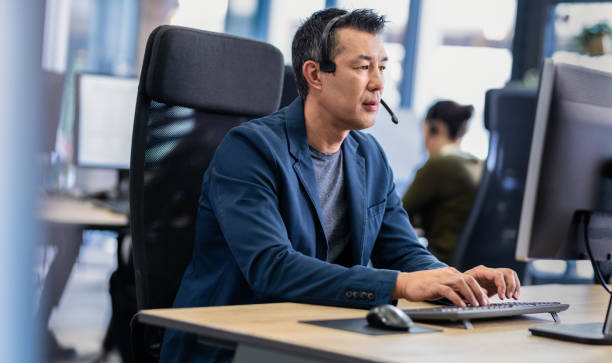 istock Man Talking To A Customer Over A Headset 1189711011