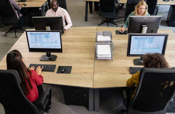 istock Call Center Employees Working In An Office 1189711036