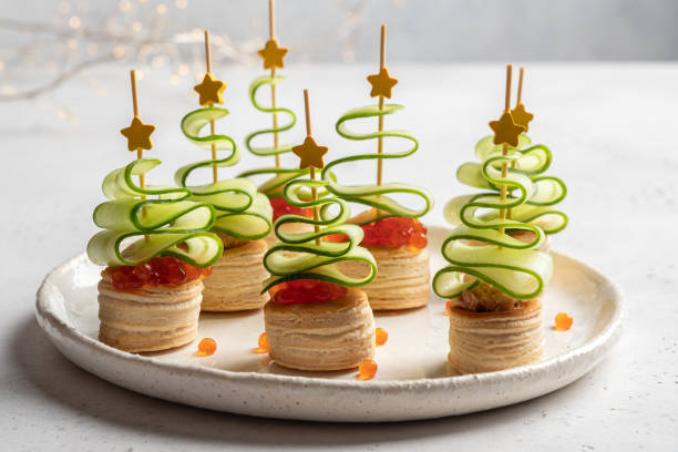 istock Christmas tree canape with cucumber slice, salmon pate and red caviar 1189712020