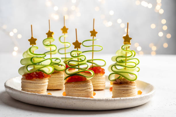 istock Christmas tree canape with cucumber slice, salmon pate and red caviar 1189712041