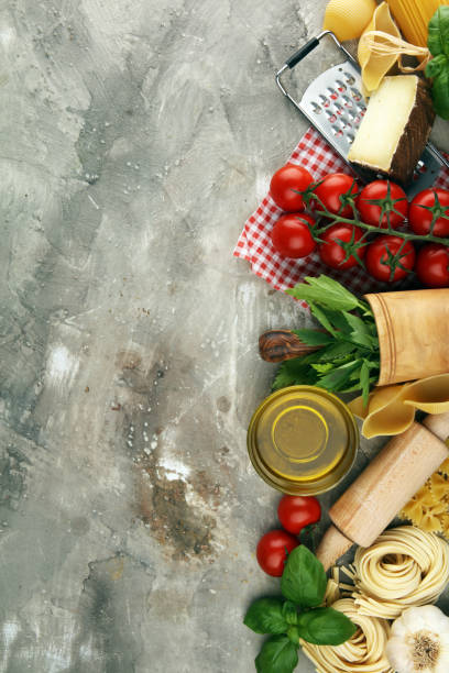 istock Pasta, vegetables, herbs and spices for Italian food on rustic table 1189712638