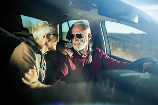 istock Happy senior couple talking while going on a trip by car. 1189713190