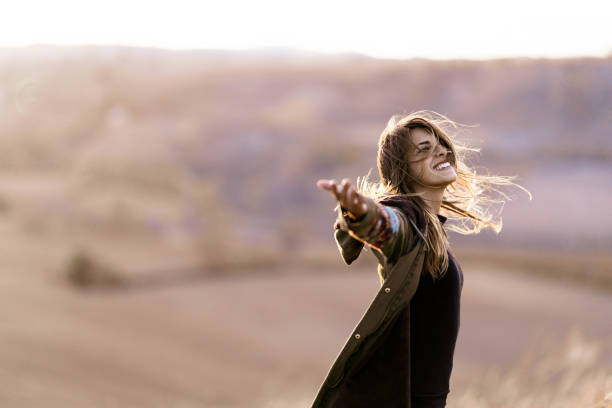 istock Happy woman having fun while spinning in autumn day. 1189713539