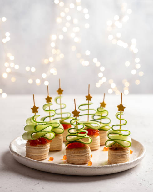 istock Christmas tree canape with cucumber slice, salmon pate and red caviar 1189713542