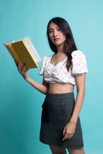 istock Young Asian woman with a book 1189713775