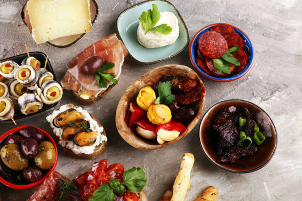 istock Appetizers table with italian antipasti snacks and wine in glasses. Brushetta or authentic traditional spanish tapas set, cheese variety 1189714979