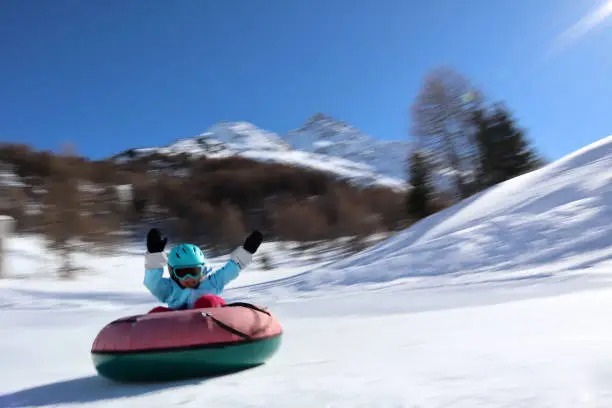 Children snowtubing in maloja engadin switzerland