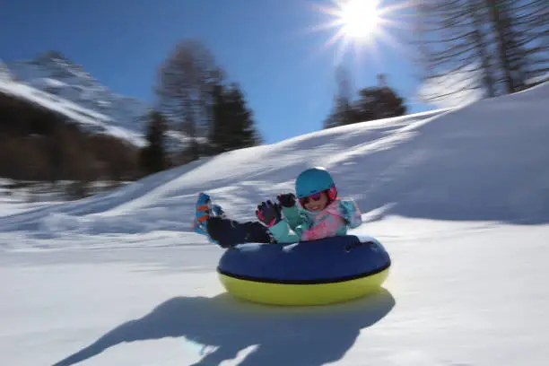 Children snowtubing in maloja engadin switzerland