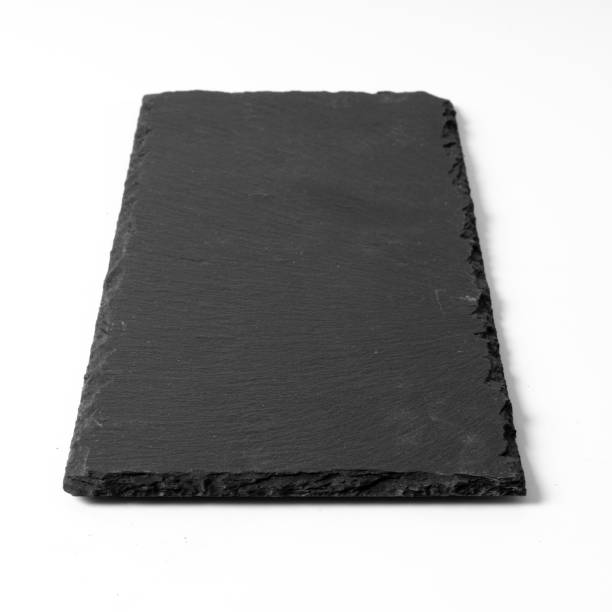 istock Black stone plate isolated on white background 1189719055