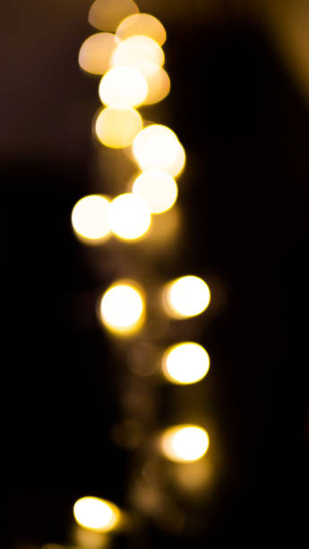 istock defocused blurred glowing shiny yellow sequins for wallpaper and design, on black background 1189719439