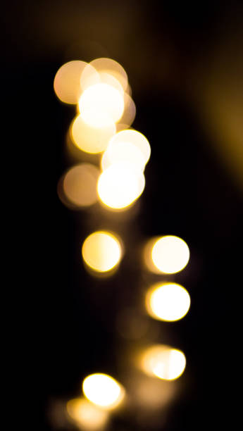 istock defocused blurred glowing shiny yellow sequins for wallpaper and design, on black background 1189719478