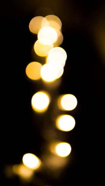 istock defocused blurred glowing shiny yellow sequins for wallpaper and design, on black background 1189719558