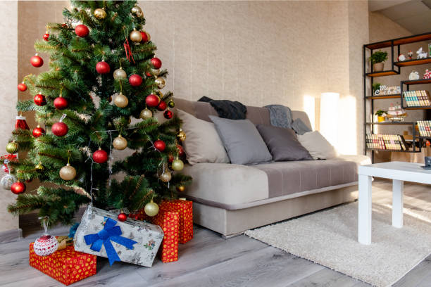 istock interior of a bright cozy room with a sofa and a Christmas decorated tree 1189722477