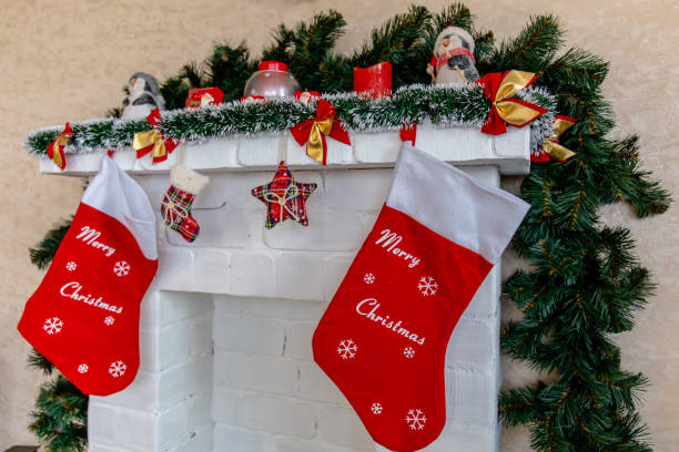 istock white fireplace decorated for Christmas with socks and Christmas tree branches 1189722478