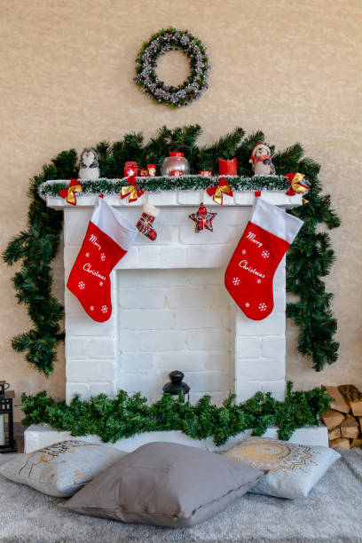 istock white fireplace decorated for Christmas with socks and Christmas tree branches 1189722486