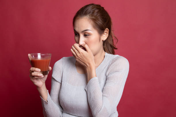 istock Young Asian woman hate tomato juice. 1189723742