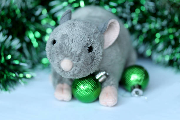 istock Cute rat or mouse soft toy with green ornaments and tinsel 1189724687