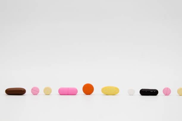istock Colorful and various type of pills on white background 1189725863