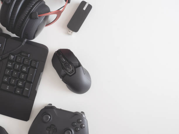 istock gamer work space concept, top view a gaming gear, mouse, keyboard, joystick, headset, mobile joystick, in ear headphone and mouse pad on black table background. 1189726973