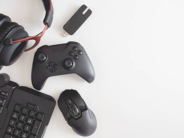istock gamer work space concept, top view a gaming gear, mouse, keyboard, joystick, headset, mobile joystick, in ear headphone and mouse pad on black table background. 1189726974