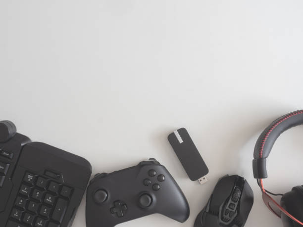 istock gamer work space concept, top view a gaming gear, mouse, keyboard, joystick, headset, mobile joystick, in ear headphone and mouse pad on black table background. 1189726975