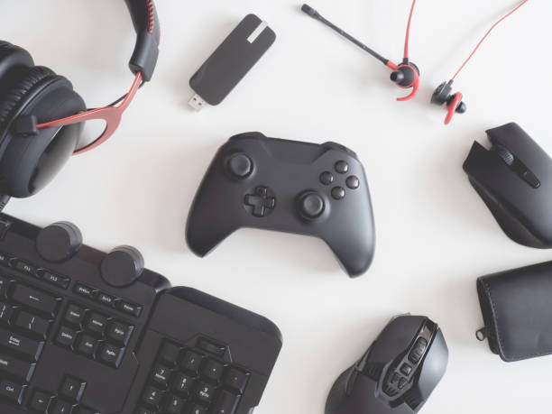 istock gamer work space concept, top view a gaming gear, mouse, keyboard, joystick, headset, mobile joystick, in ear headphone and mouse pad on black table background. 1189726981