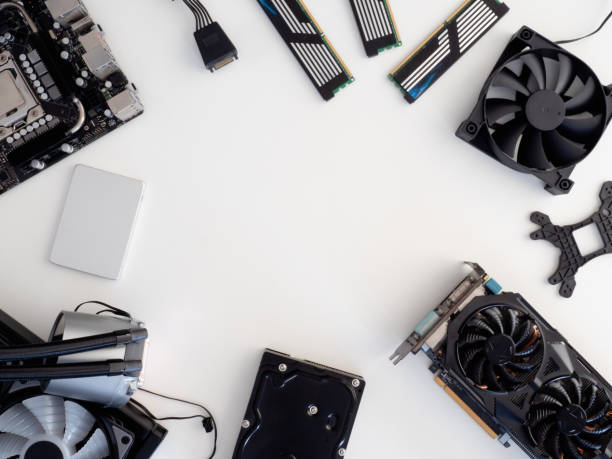 top view of computer parts with harddisk, solid state drive, ram, CPU, graphics card, liquid cooling and motherboard on white table background. stock photo
