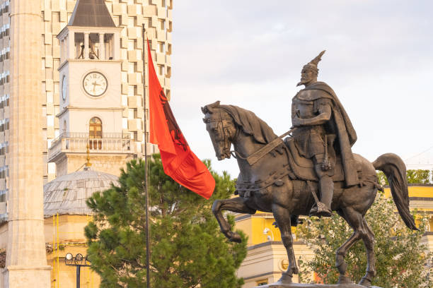 monument to Skanderbeg in Scanderbeg Square in Tirana center monument to Skanderbeg in Scanderbeg Square in the center of Tirana, the Albanian Capital. Clock tower Sahati and national flag tirana photos stock pictures, royalty-free photos & images