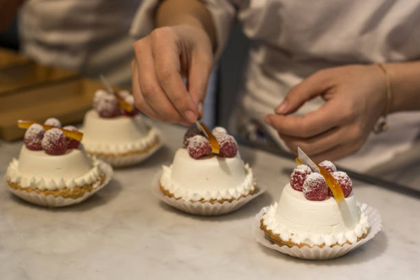 istock Female hands decorating by berries tart with custard 1189732667