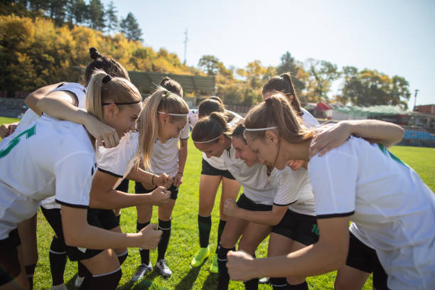 istock Female soccer players huddling 1189735725