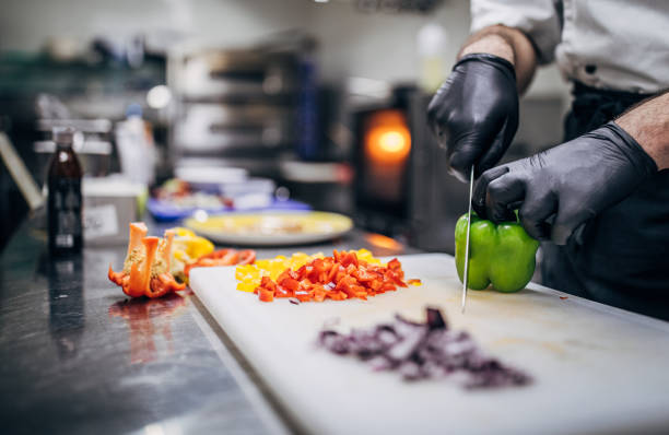 chef cutting paprika - kochen stock-fotos und bilder