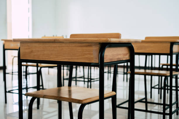 istock School empty classroom or lecture room interior with desks chair iron wooden whiteboard for studying lessons of secondary education in high school thailand. Learning and Back to school concept 1189736614