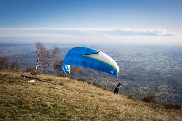 istock paraglider launching from the edge of mountain 1189736898