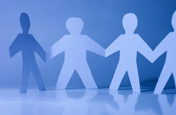 istock Paper little men holding hands 118973759