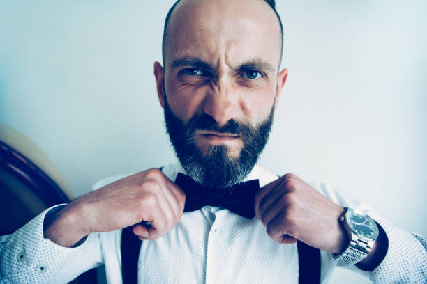 istock close up. man straightening his bow tie 1189738497