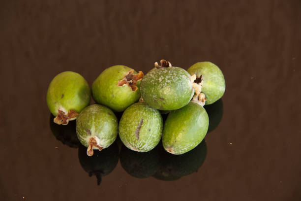 istock Fresh fruits of feijoa on a glass table with a reflection 1189740811